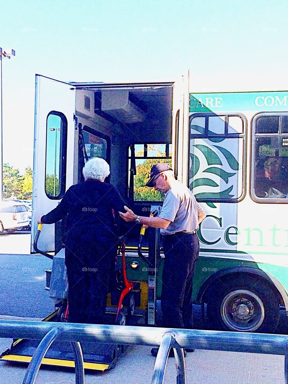 Elder  getting a a helping hand on the shuttle bus 
