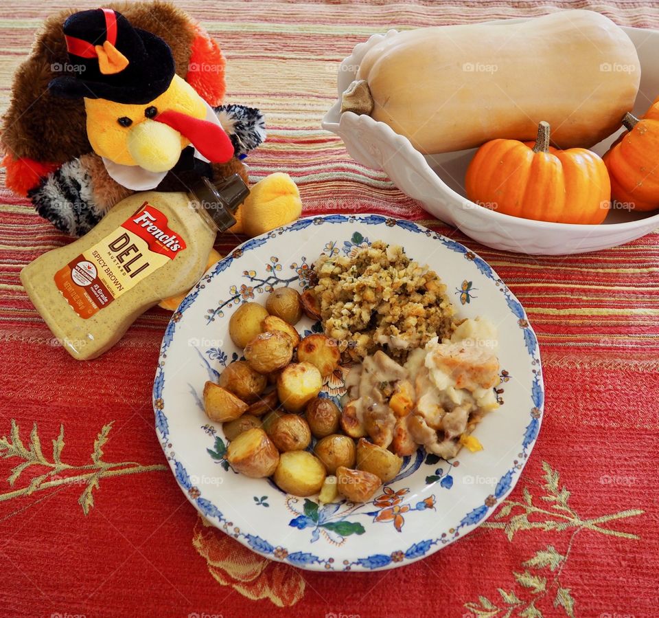 Thanksgiving plate of turkey in a creamy French’s deli and honey mustard sauce with stuffing and roasted potatoes.