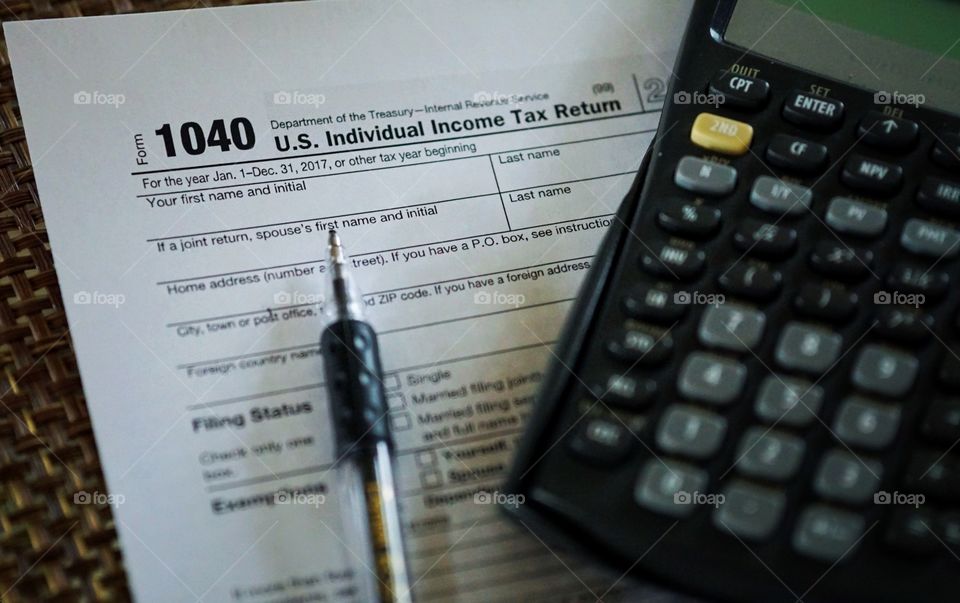 Tax Form 1040 with Pen and Calculator 