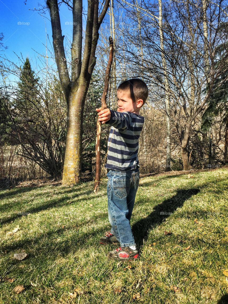 Boy shoots a bow at target