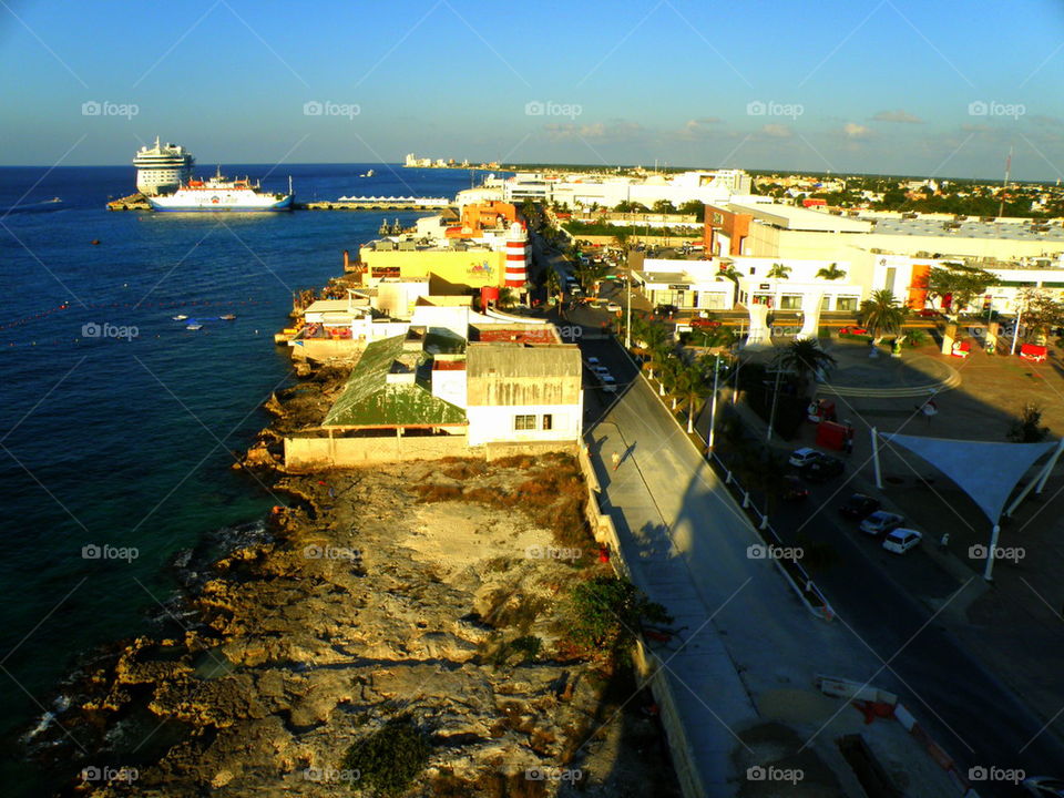 From the Top. Sitting on the top of an open air balcony in a restaurant overlooking the city and port of Cozumel, Mexico