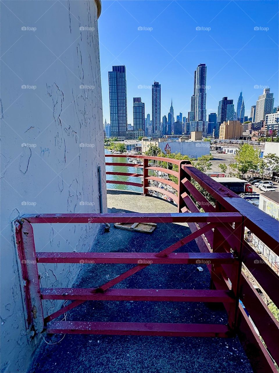 This is the center outpost of the “Pulaski Bridge” at “Newtown Creek” that connects “Greenpoint”, Brooklyn to LIC, Queens. In the distance we see “Manhattan” including the “Empire State Building”. 2024. Hypnotic Productions