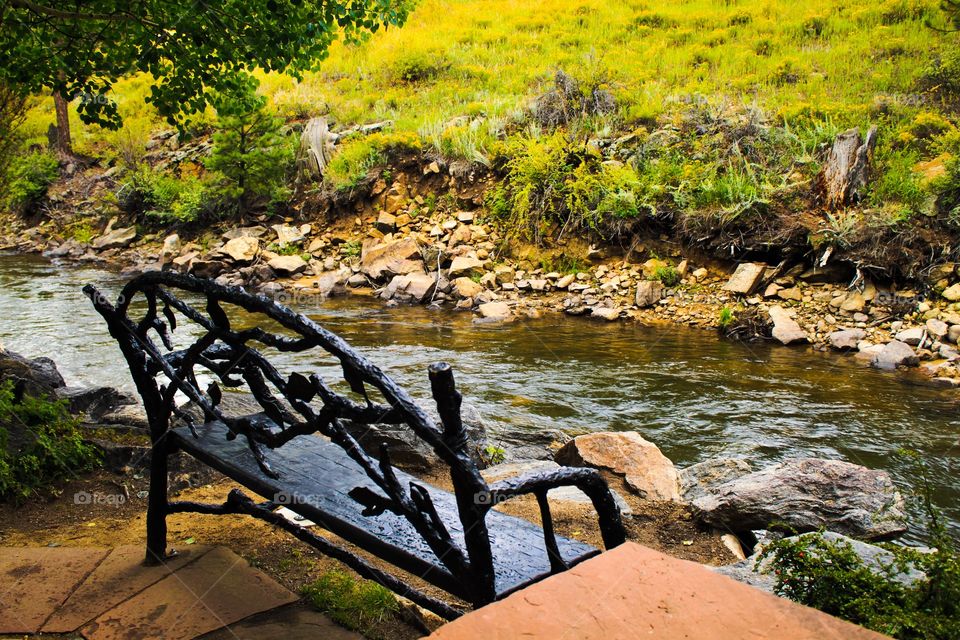 Empty wooden bench near lake