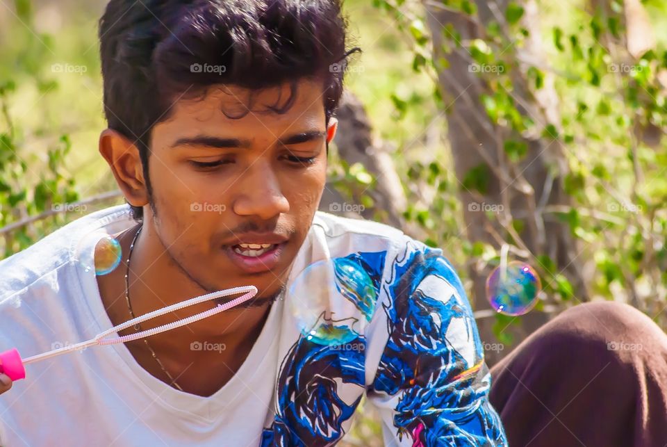 Man blowing soap bubble