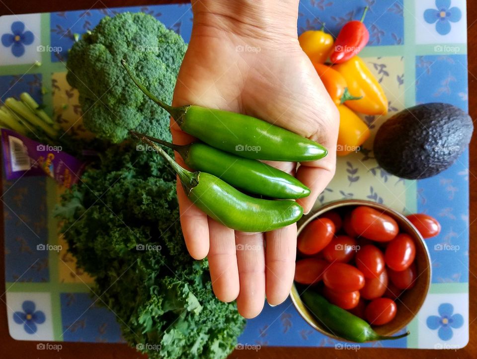 Holding Serrano chilli