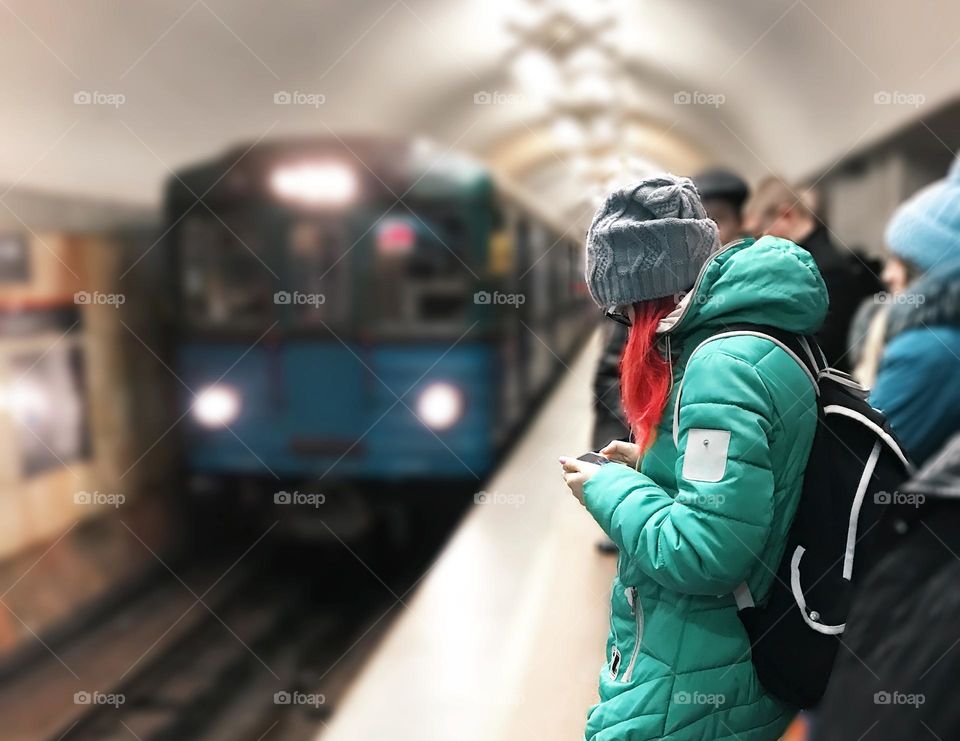 Using mobile phone at subway station 