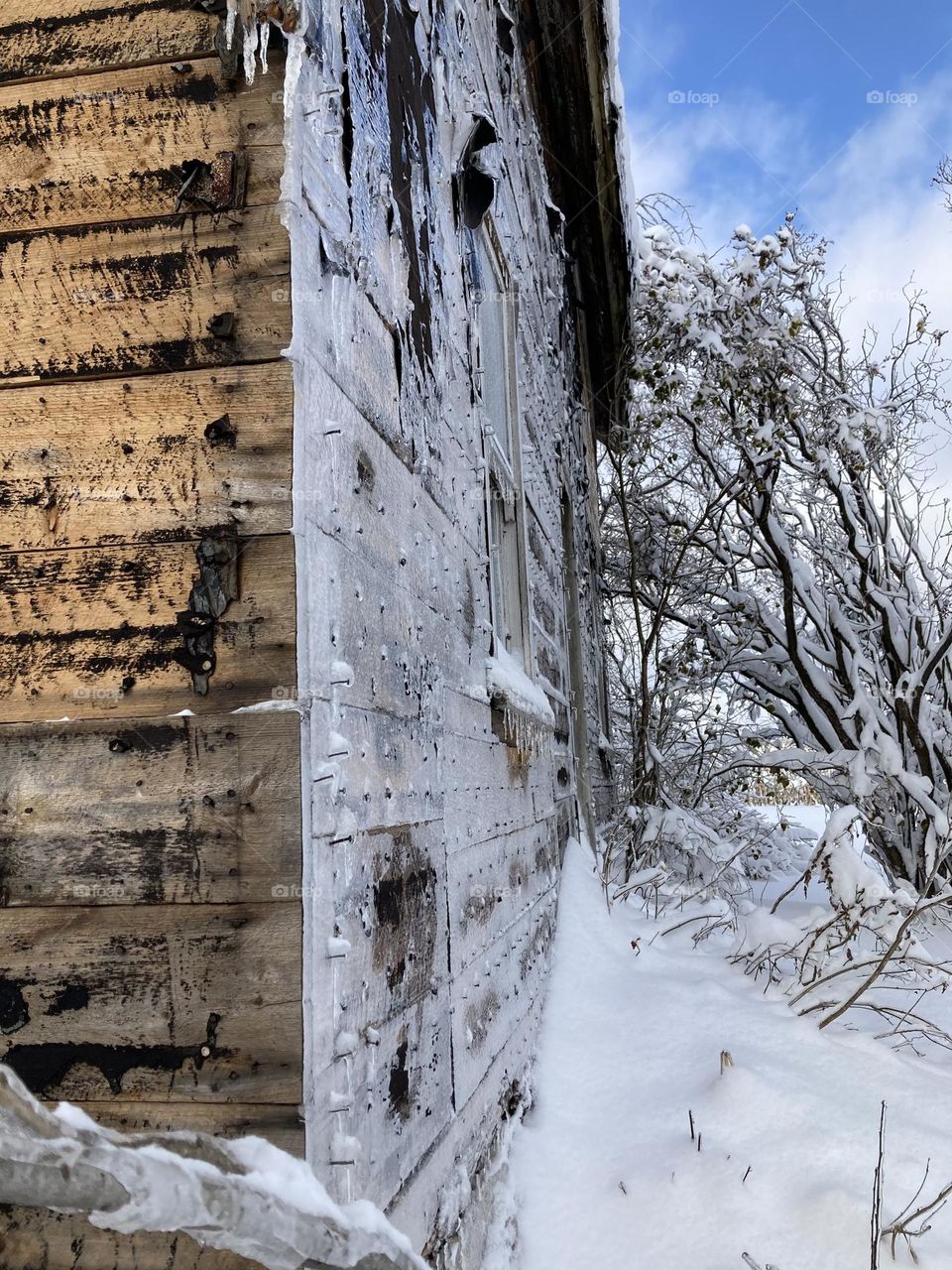 Ice covered farmhouse on a cold winter day 