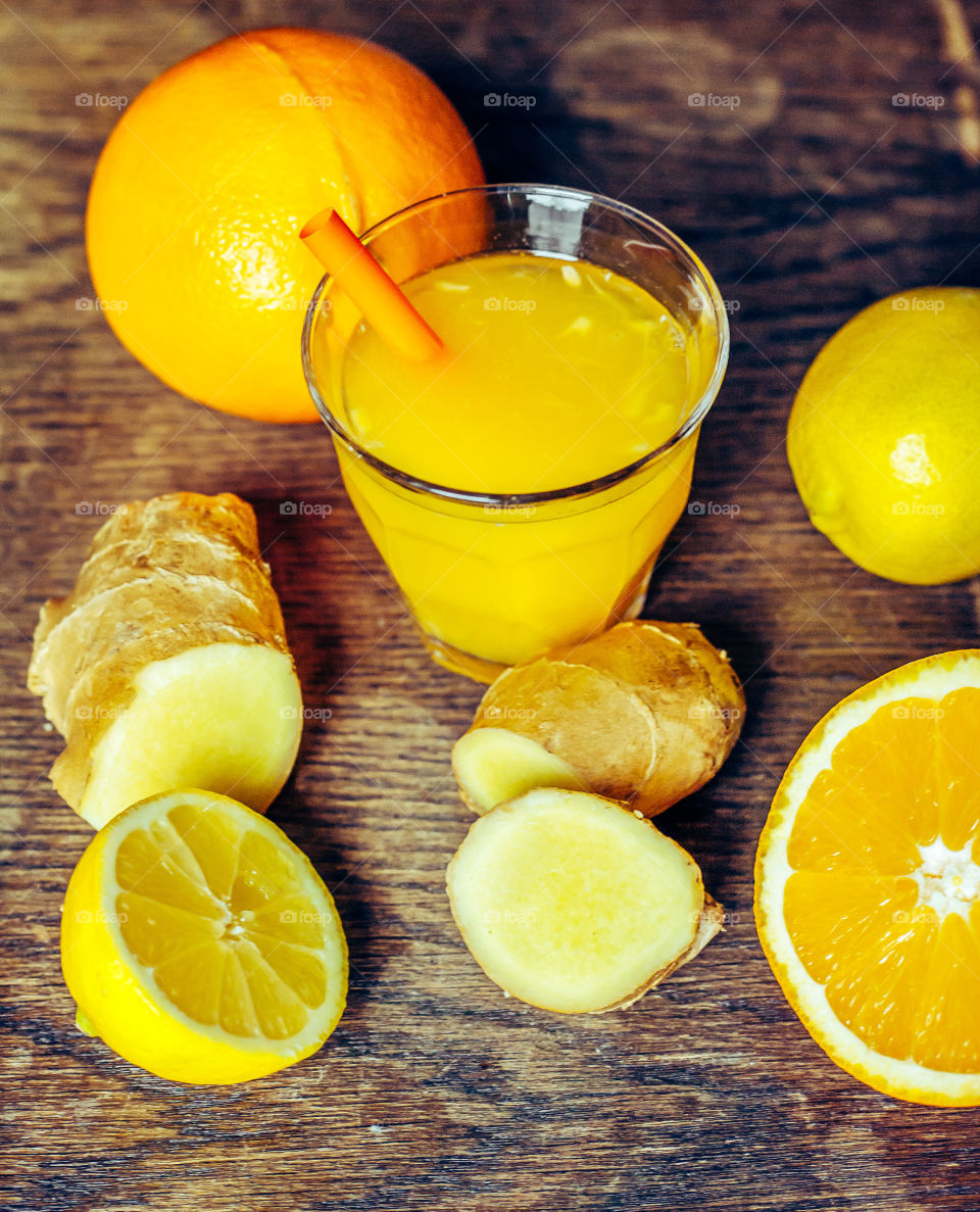 Ginger Shot on daylight Rustic Wooden background 