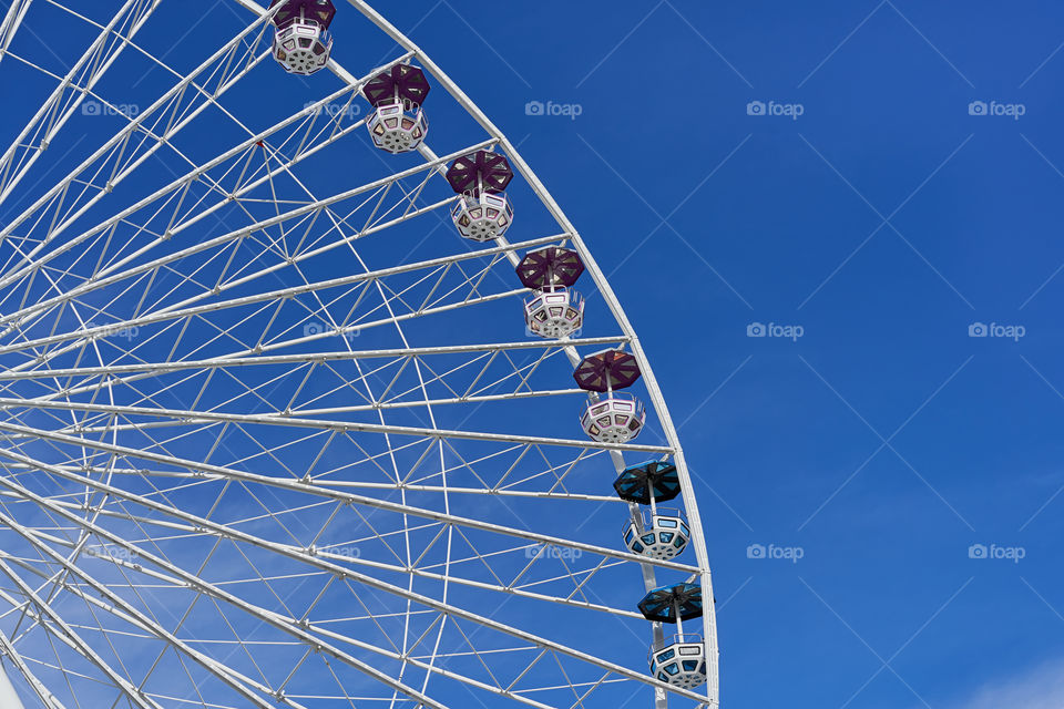 Ferris wheel over blue sky 