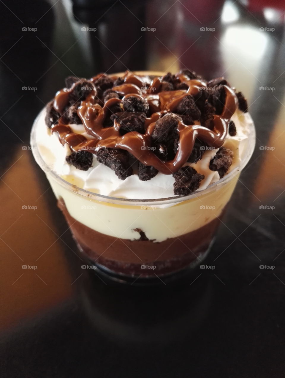sweet for coffee with cream, cookie, caramel sauce in clear cup
