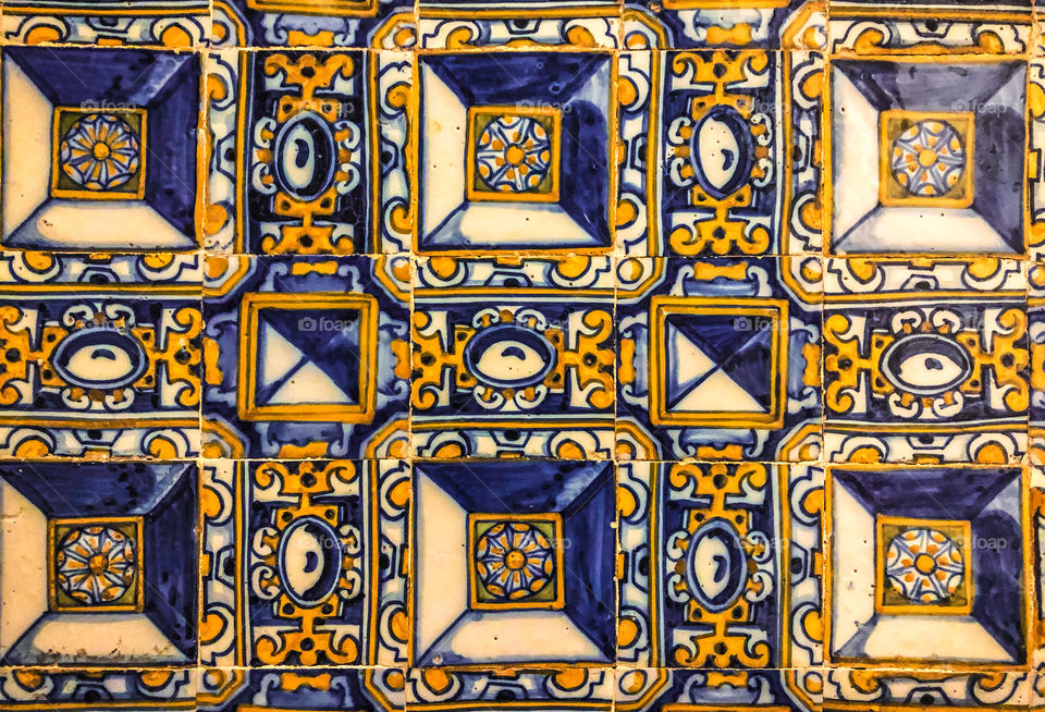 Traditional blue and orange Portuguese ceramic tiles or “azulejos”