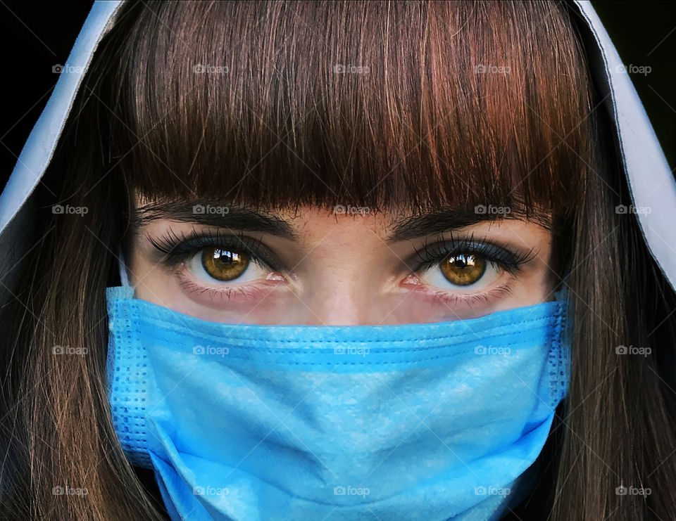 Blue medical mask on face 