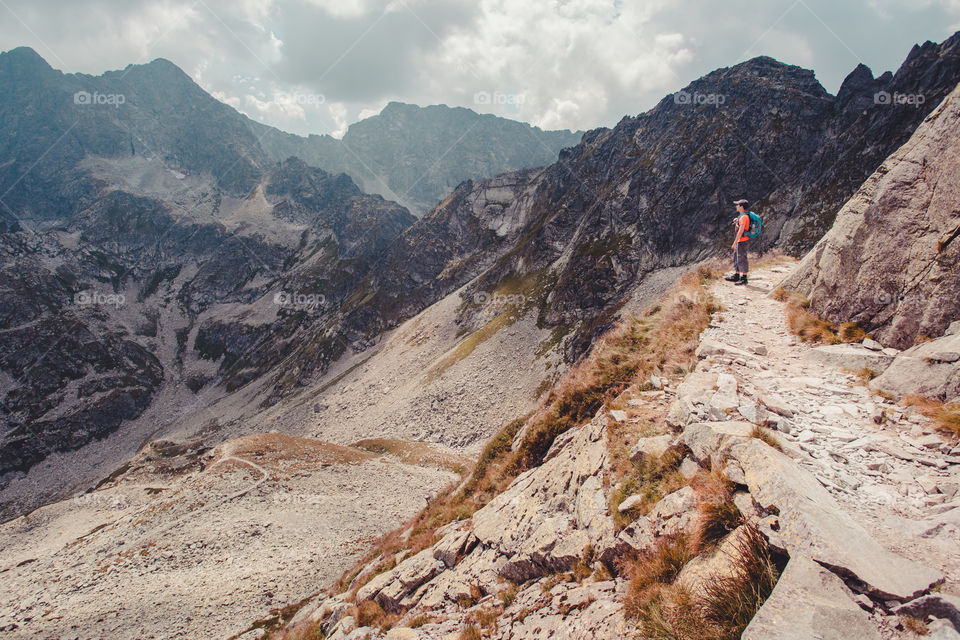 Hiker standing on mountain trail