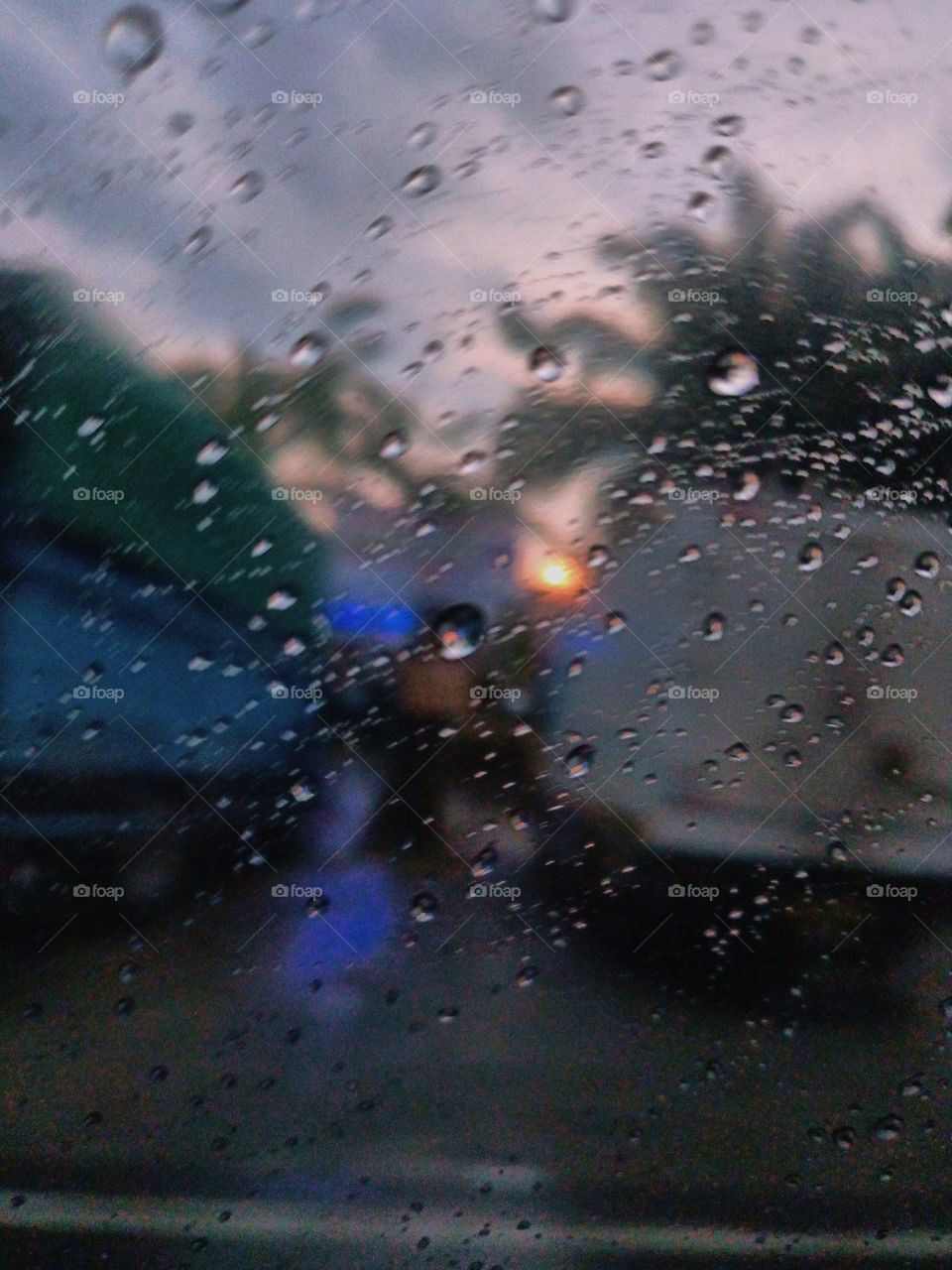 Selective focus on the rain drops on the windshield of the car. After rain at the rainy season