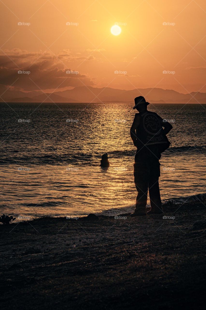 Beutiful sunset, silhouette of man looking at the beauty of passage