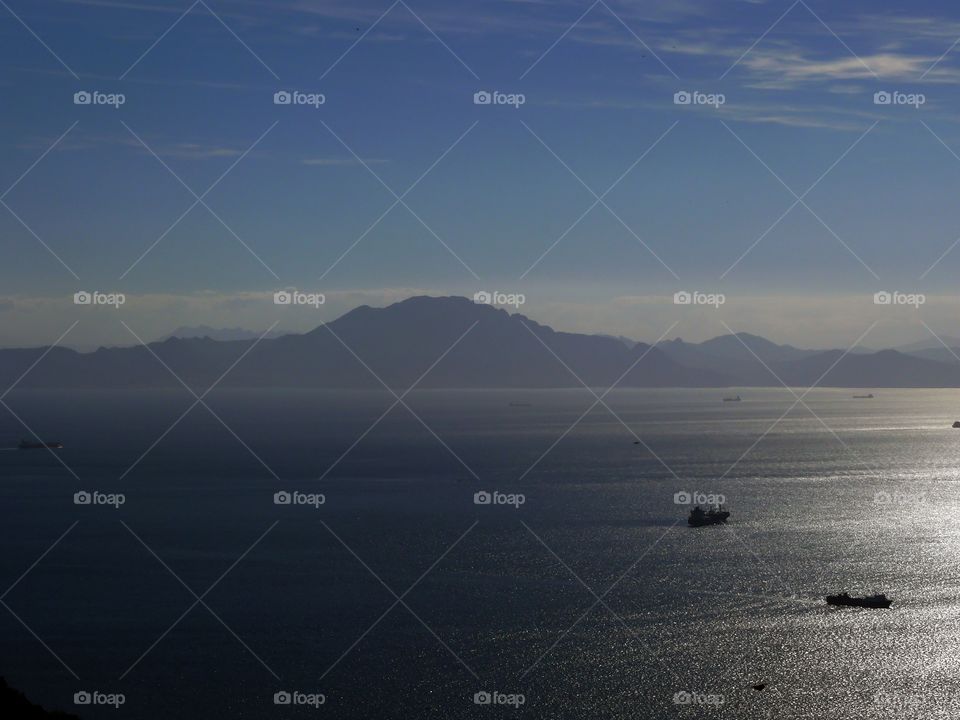 Silhouette of mountain range on the African continent and ships on the Strait of Gibraltar.