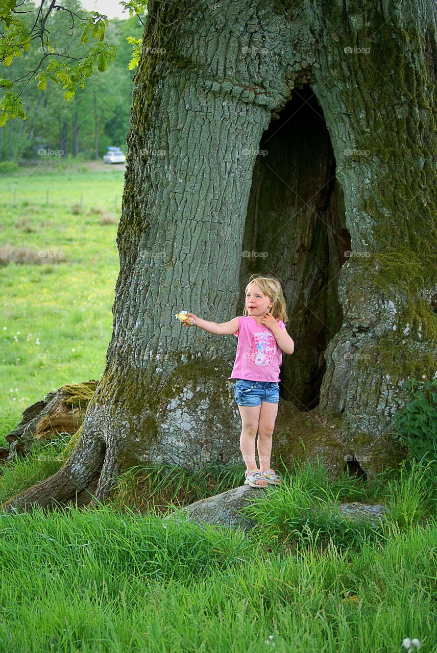 Girl in front of a big old tree