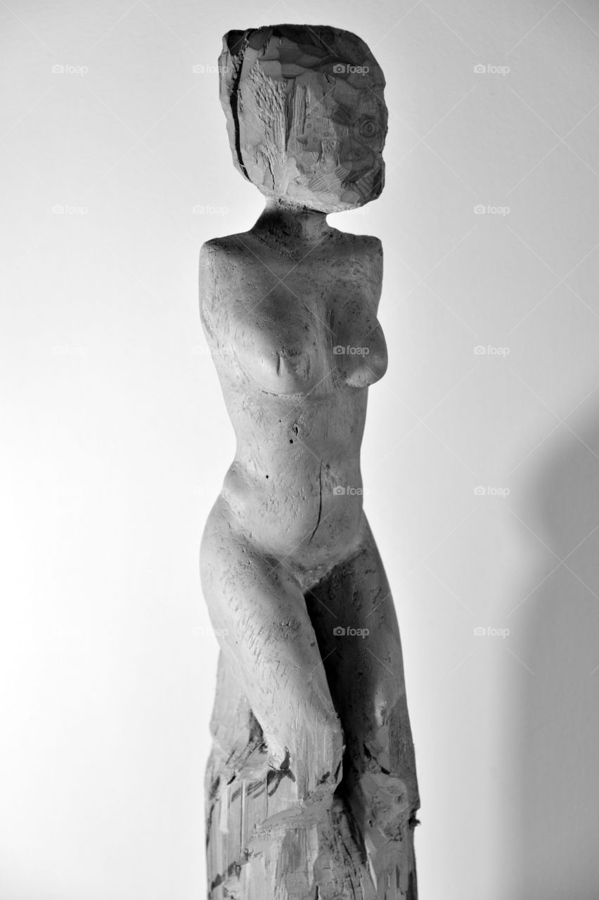 naked body of a woman, wood carving