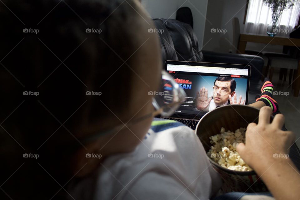 teenager watching movie on computer