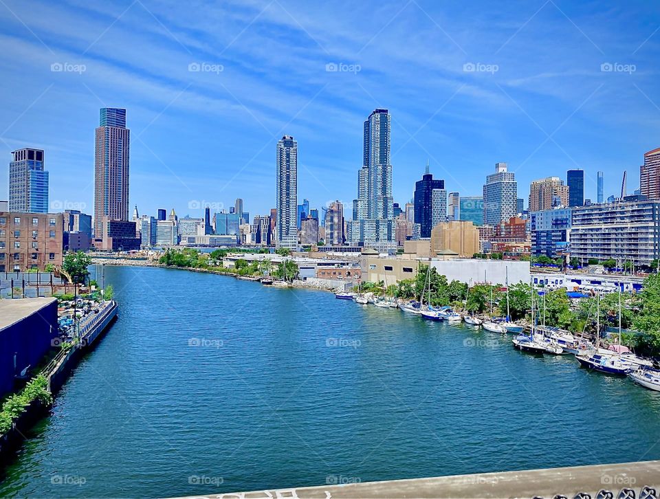 A large panorama showing the “East River” at “Newtown Creek” as seen from the “Pulaski Bridge” on a bright sunshiny day in July of 2022. Hypnotic Productions