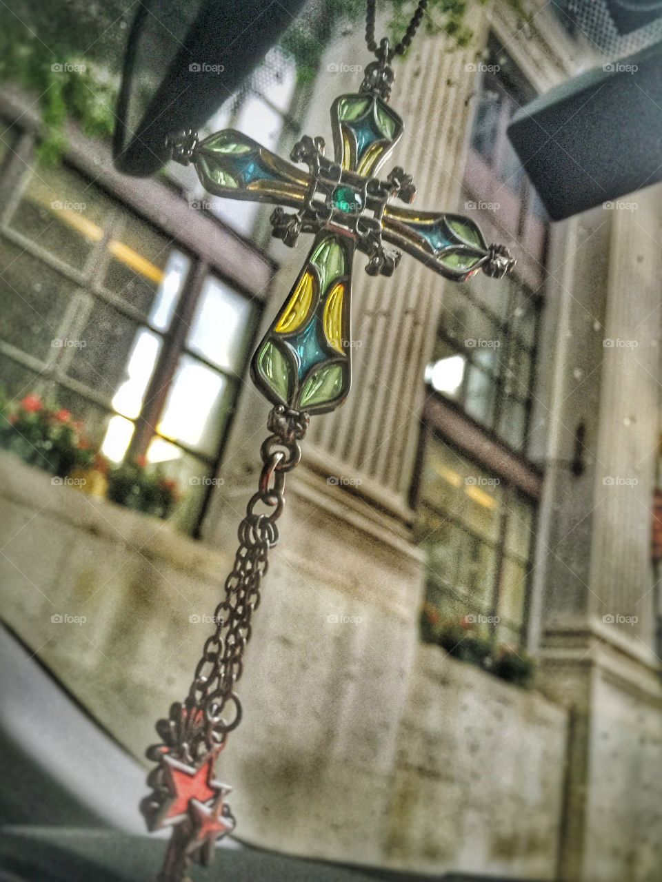 Cross. A cross hanging on a rear view mirror 