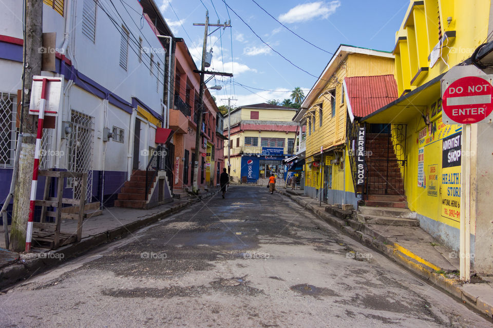 Port Antonio, Jamaica – January 1, 2014: Unidentified people walking on the colorful streets of downtown Port Antonio, Jamaica on New Year’s Day morning 2014.