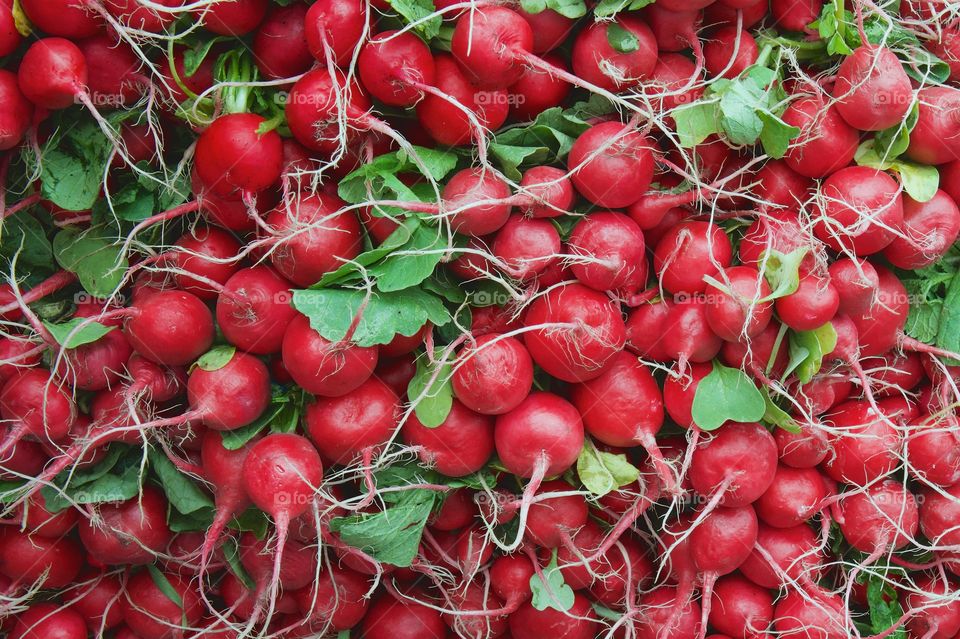 Radishes on sale at an outdoor market stall
