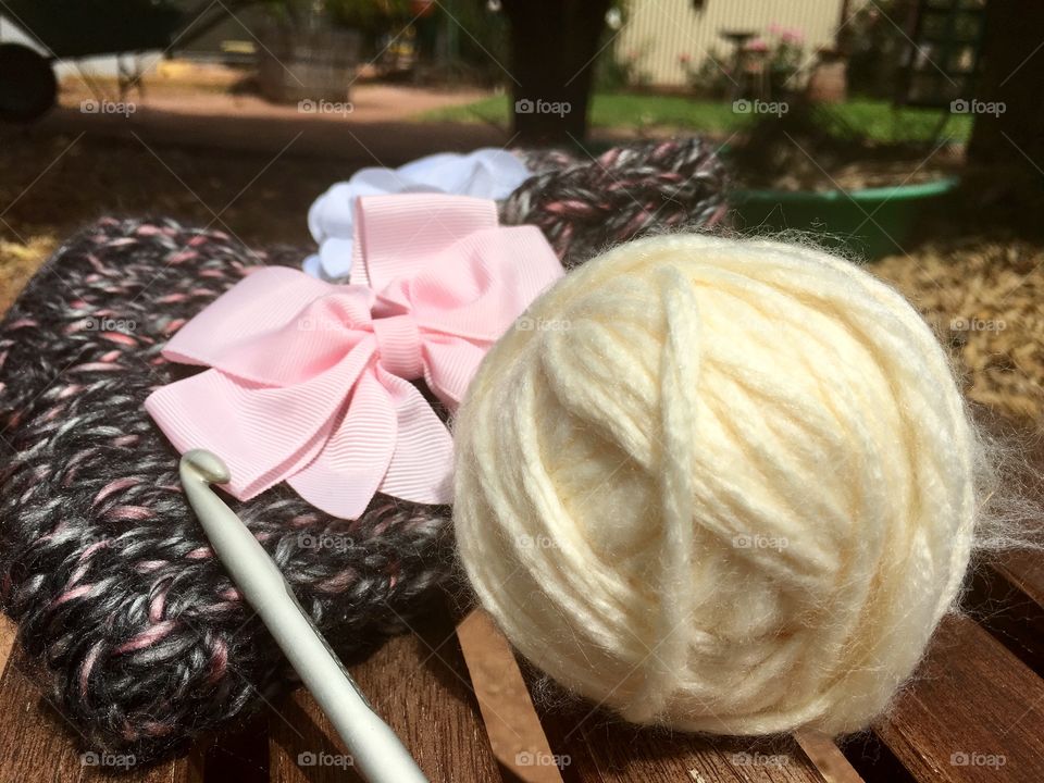 Ball of cream coloured wool with crocheted headbands, outdoor still life autumn 