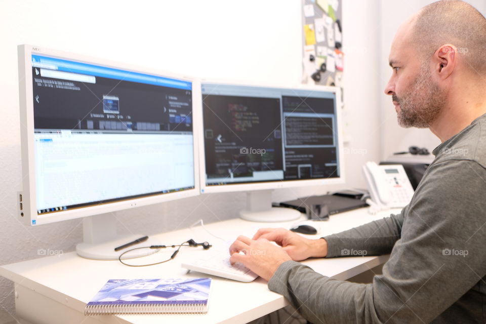 a man at his computer workplace