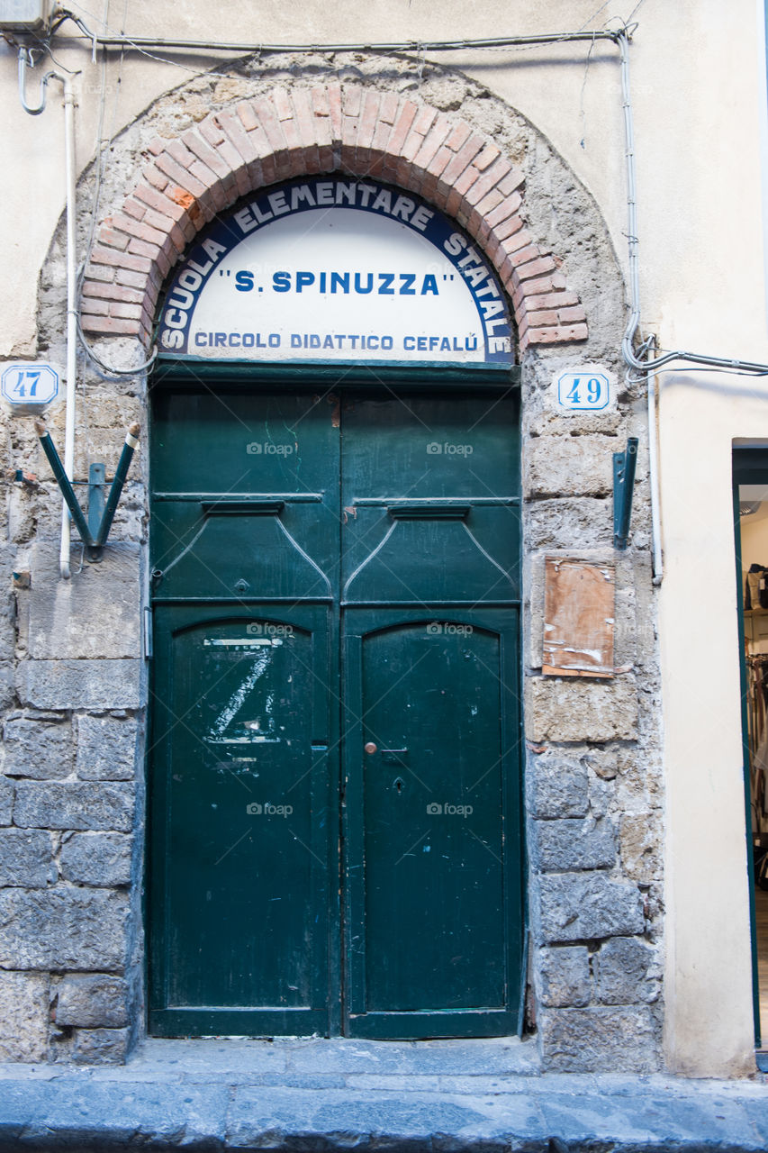 Old door in the city of Cefalu on Sicily.