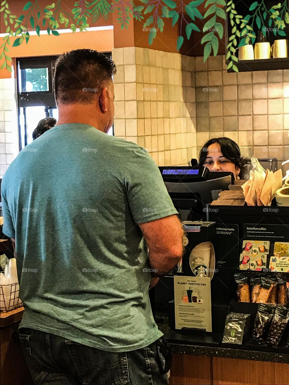 Ordering something to consume at Starbucks.