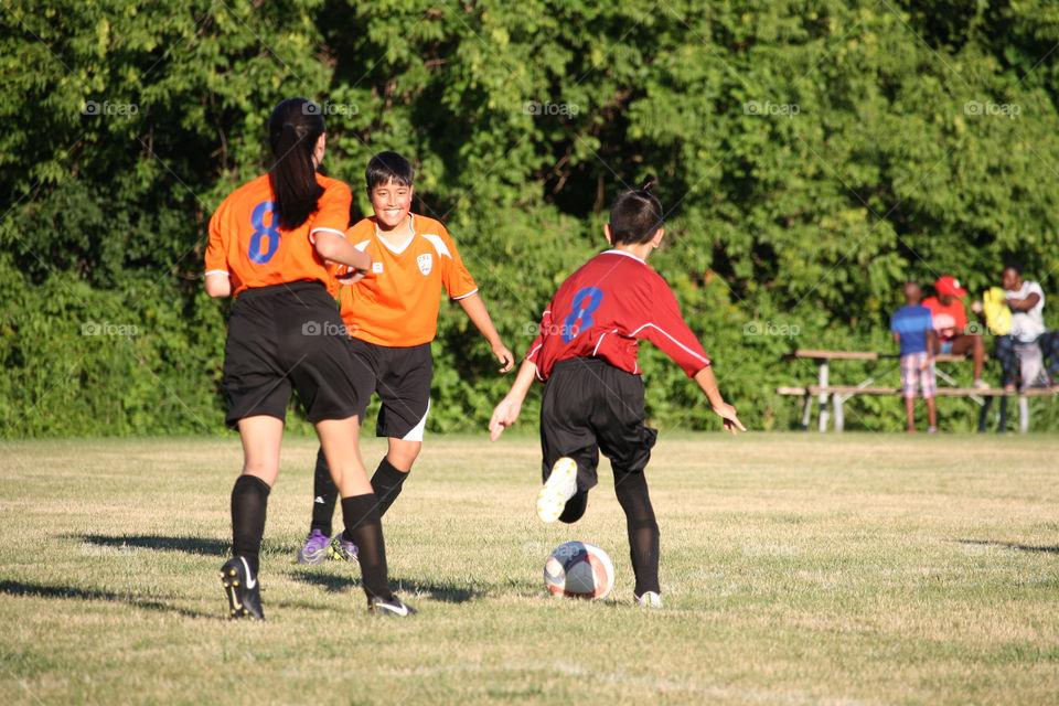 Teenagers are playing soccer