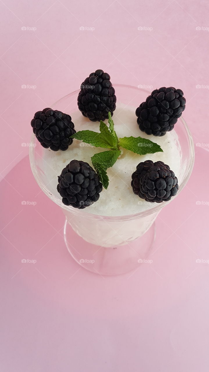 Lychee sorbet with Blackberries and garnished with mint.  summer drink