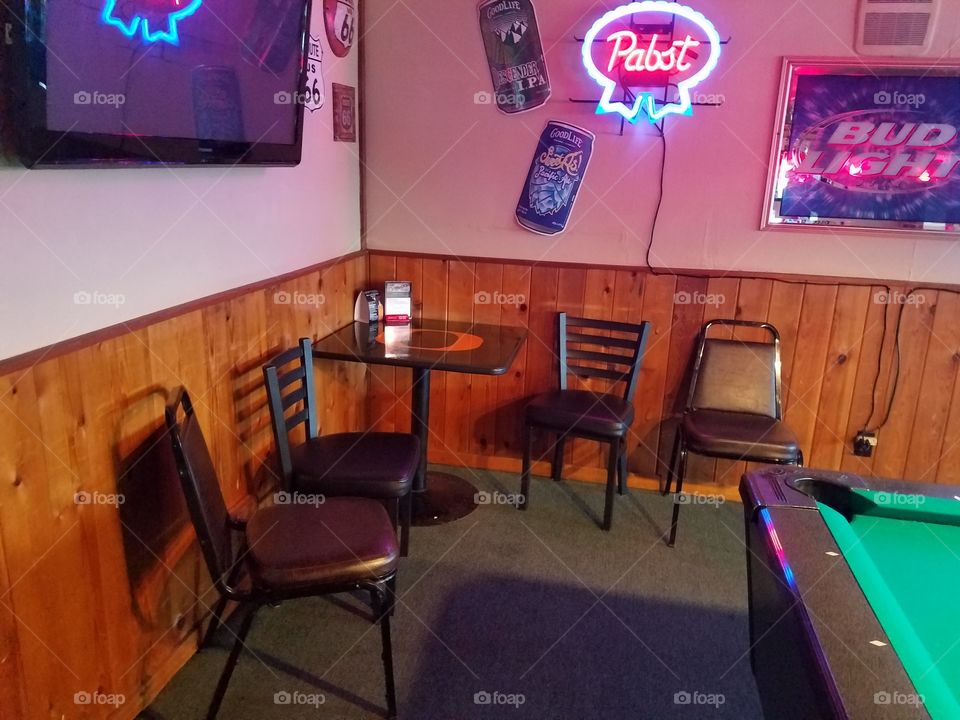 Corner table and four empty chairs.