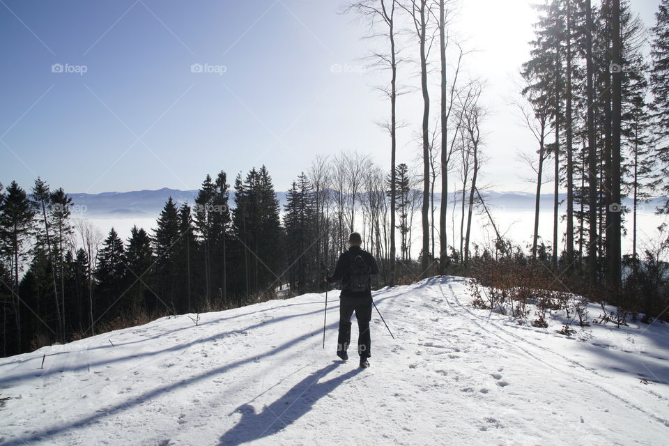 Hiking man on the hill on snow during winter. Slovakia
