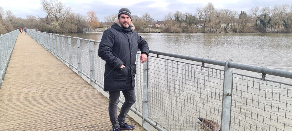 walking on a bridge over a pond