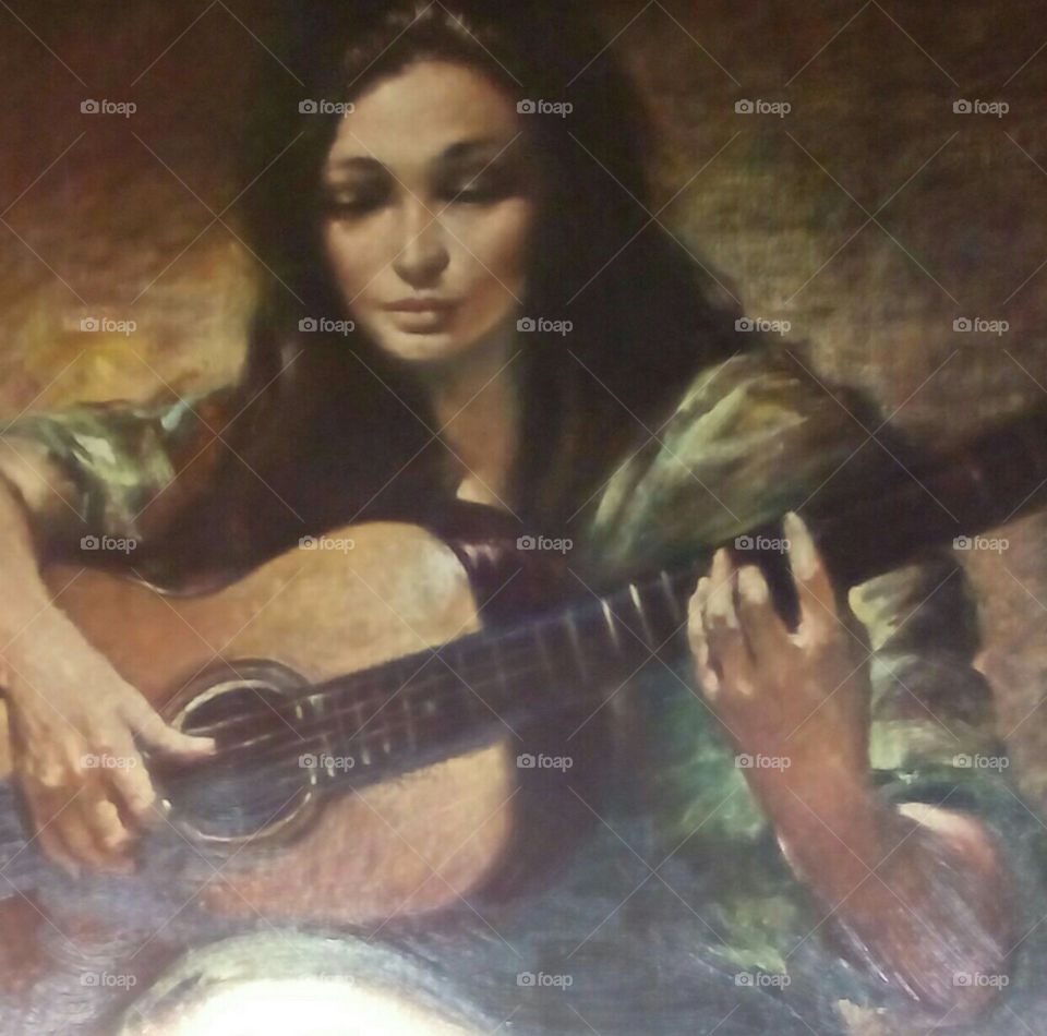 Photograph of a woman playing guitar