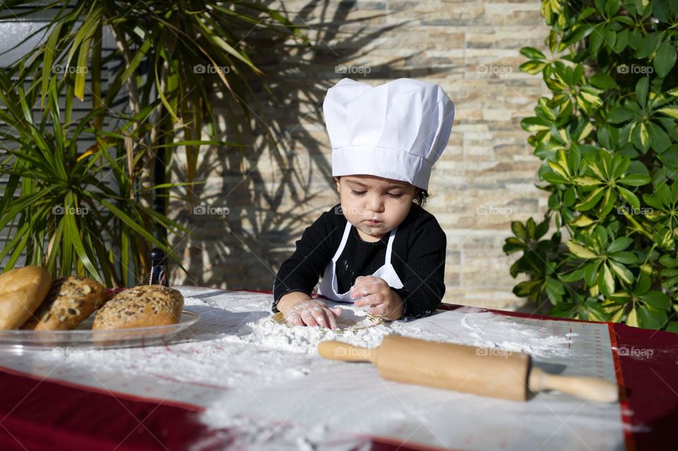 little girl chef preparing bread