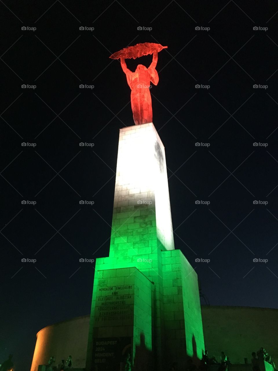 Liberty Statue illuminated with the colors of the Hungarian flag. Budapest, Hungary. 