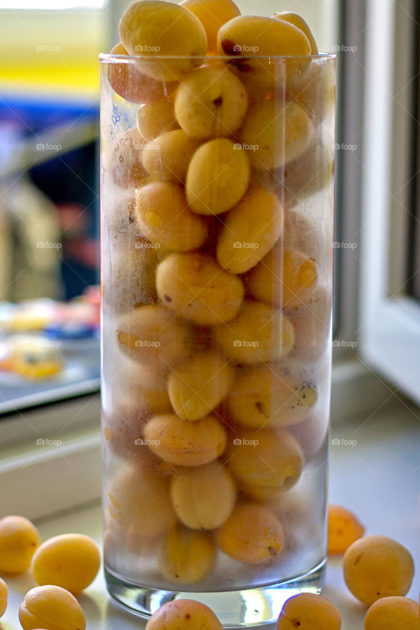 apricots in a vase on the window