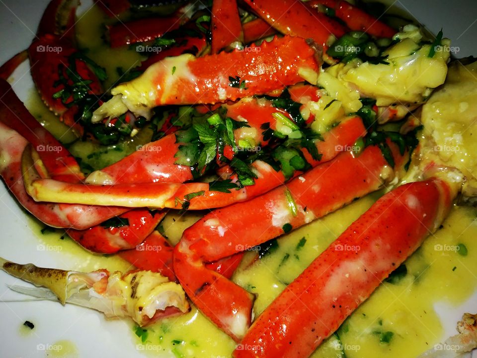 crab legs soaked in a butter garlic sauce