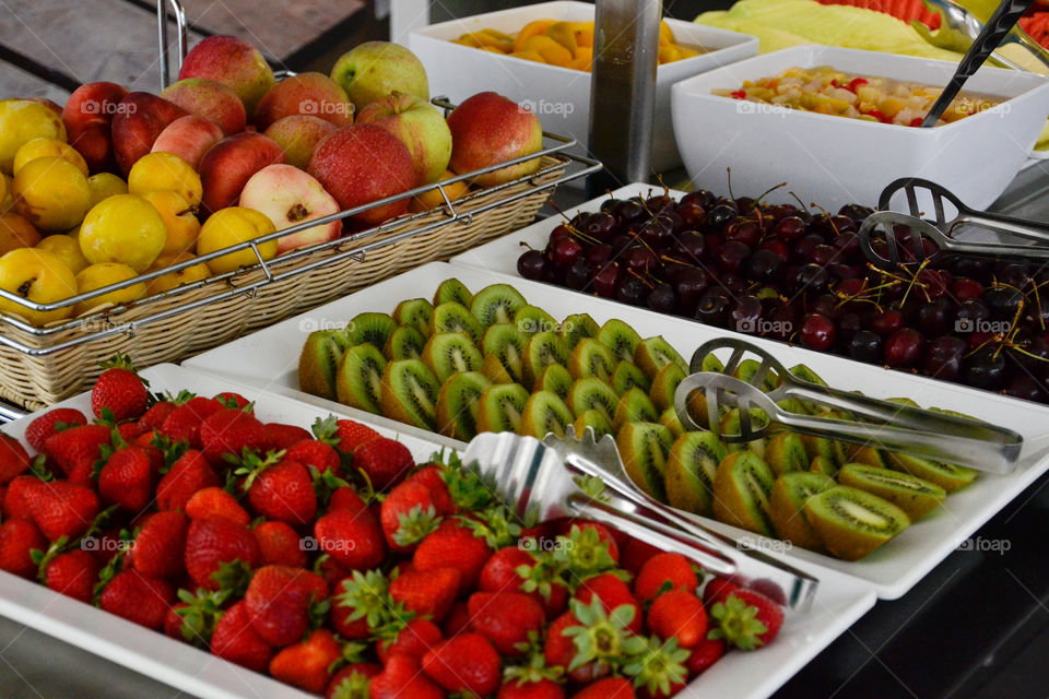 Fruit buffet with Strawberry, Kiwi and Cerry and apple in the back.