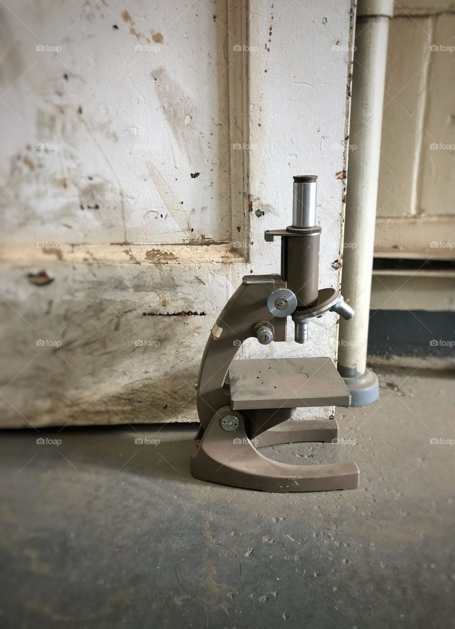 Old microscope being used as door stopper 