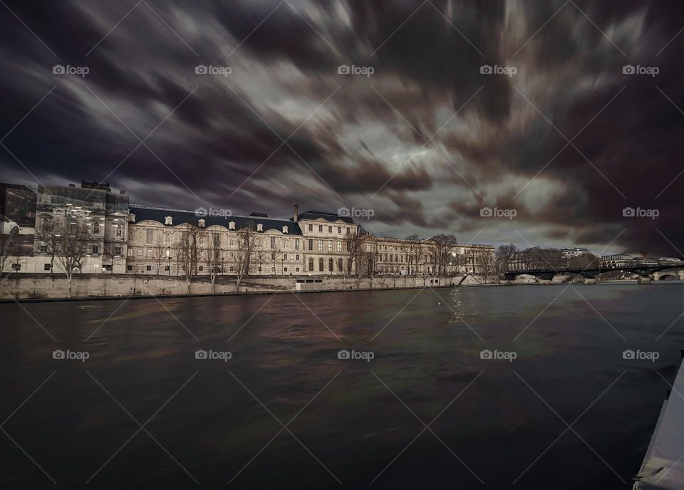 Clouds motion over the river and buildings 