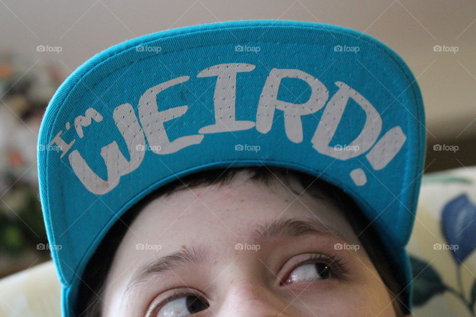 Extreme close-up of boy with text on his cap
