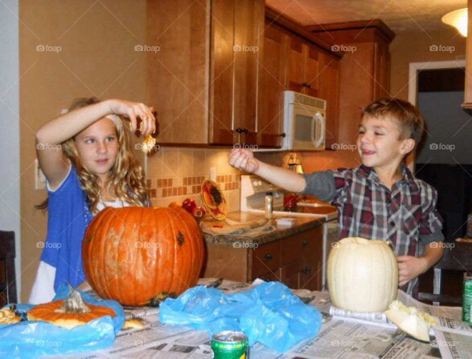 Kids Carving pumpkins for Halloween