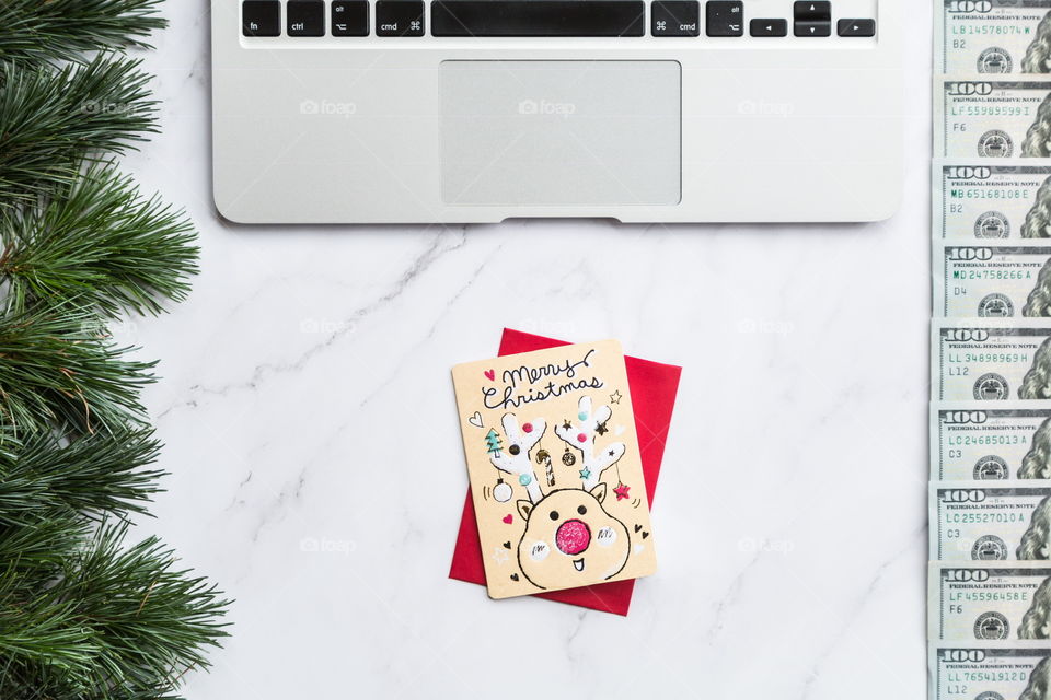 Holiday shopping. Flatlay items. Laptop, bag, Christmas tree . Card with deer