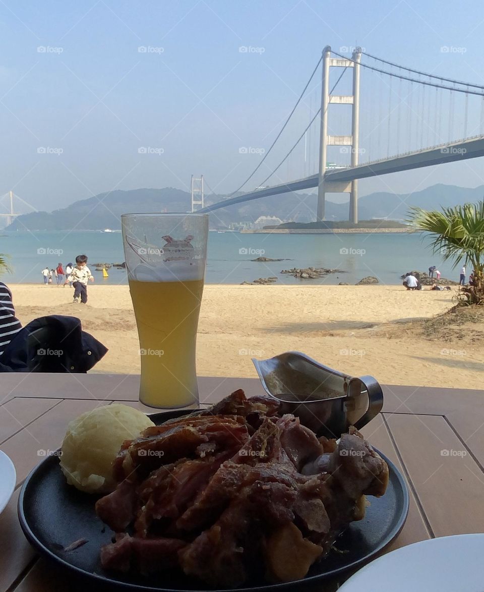 The sun of the beach served with grilled knuckle and cold beer