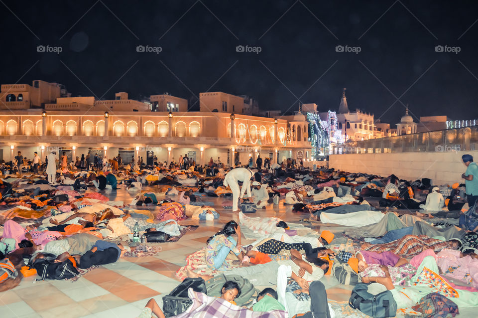 Amritsar, India - MAY 16 2016: People sleeping on the floor of of the Sikh Golden Temple in Amritsar, India.