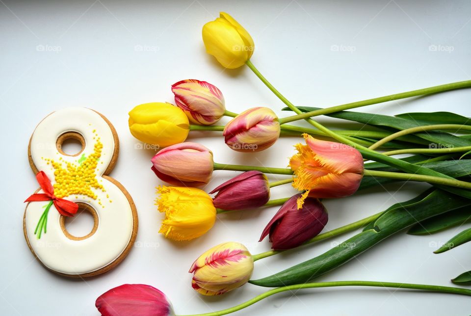 8 March gingerbread and colorful tulips on a white background women's day